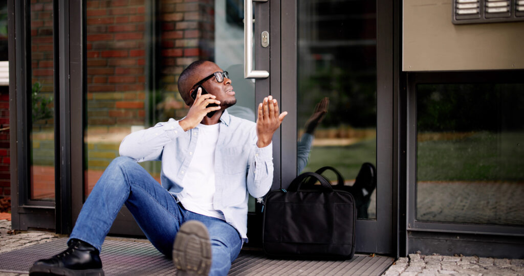 Frustrated African American Man Locked Out of House, Waits for Locksmith